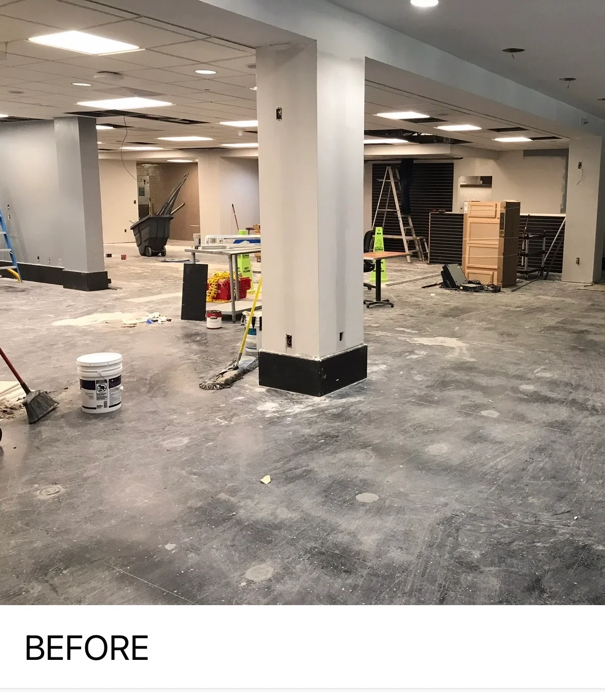Commercial interior space with primed drywall columns and prepared walls ready for painting