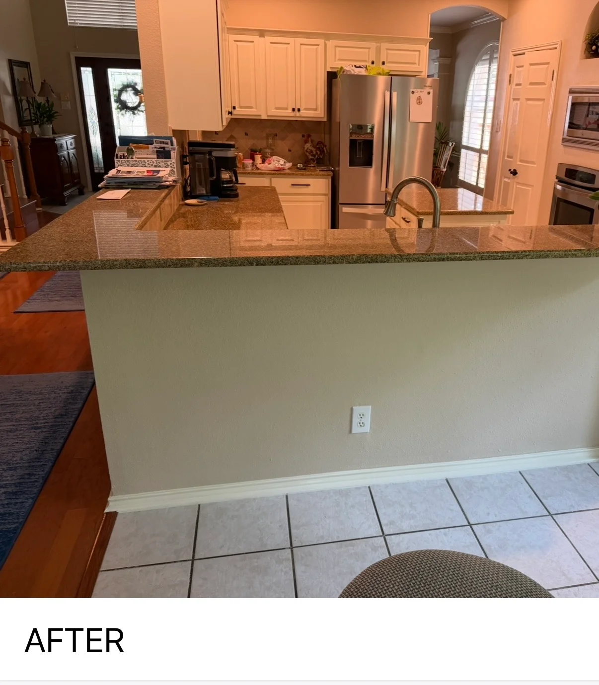 Freshly painted kitchen and dining area with neutral walls, white trim, and granite countertops