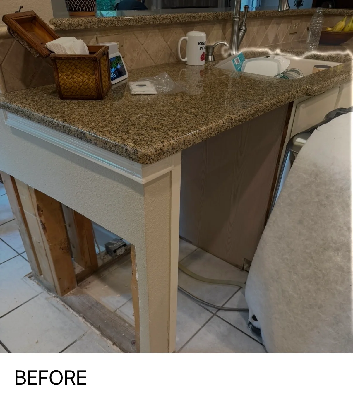 Kitchen island with newly installed drywall base and granite countertop in progress