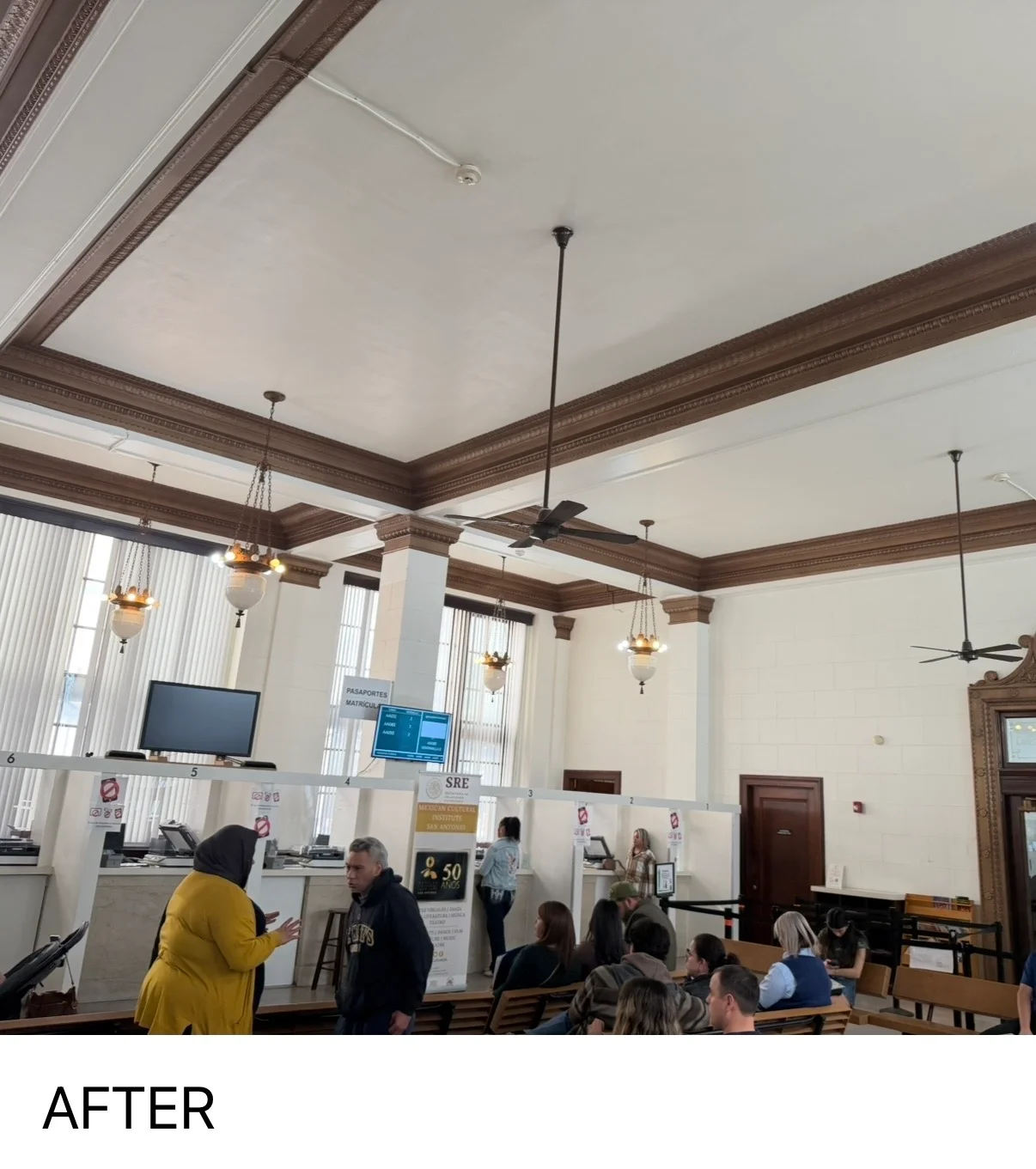 Historic commercial interior with painted coffered ceiling, wood beams, and pendant lights