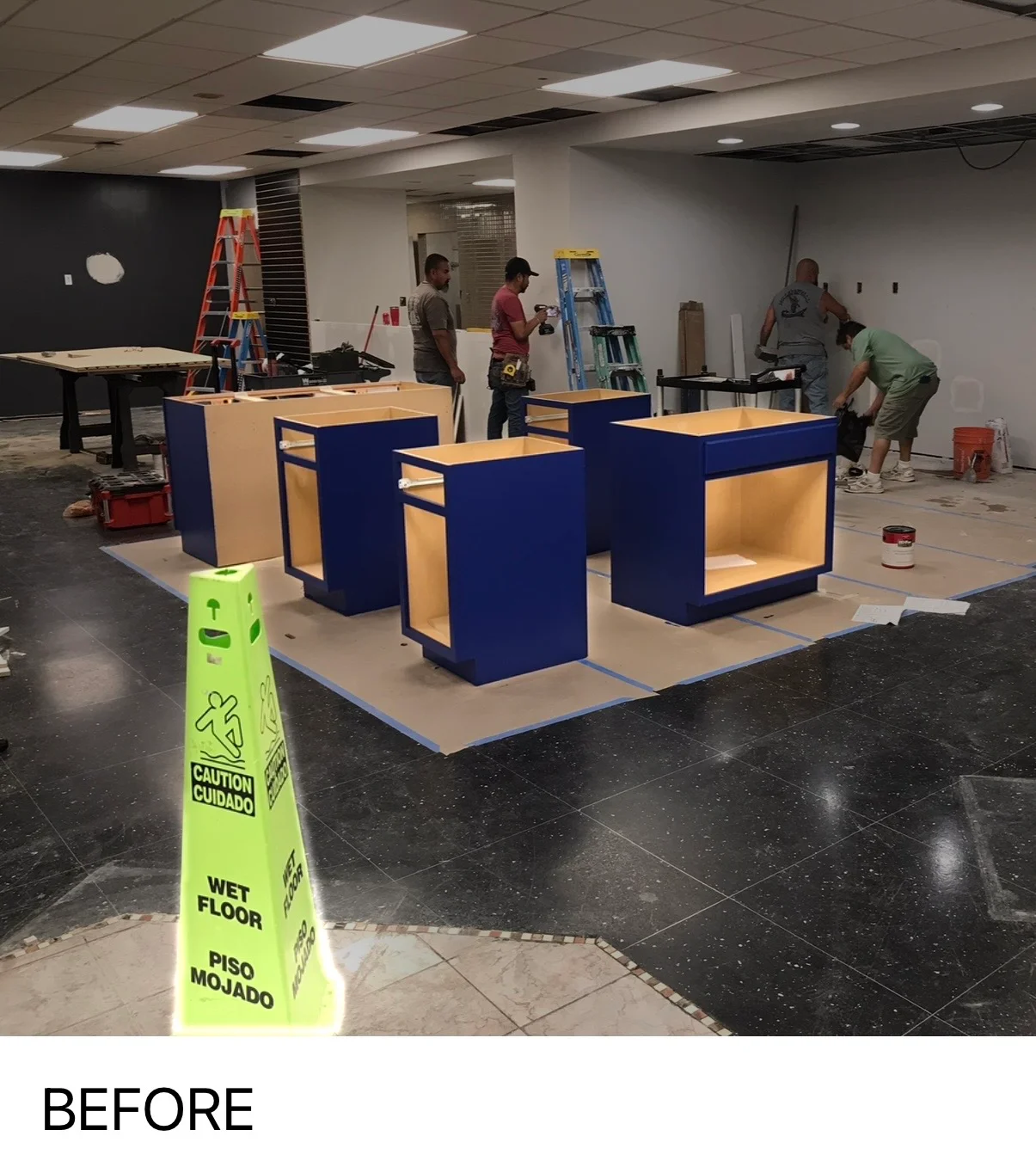 Commercial interior painting project with navy and wood cabinetry under construction in Boerne