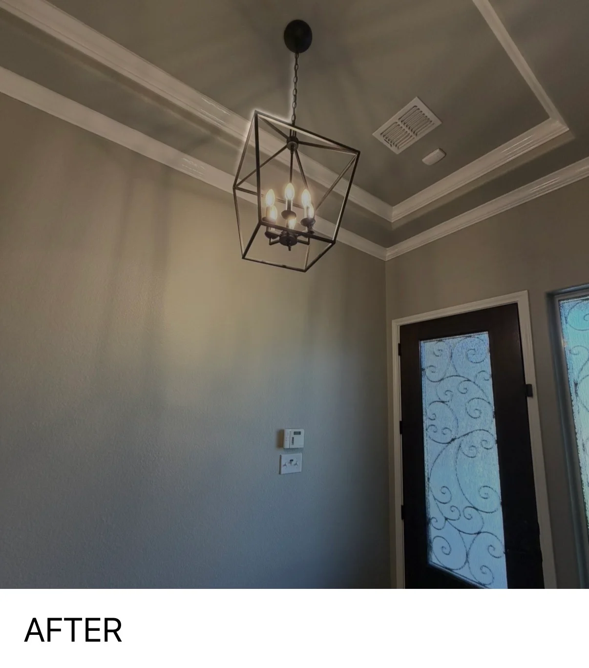 Newly painted interior room with taupe walls, white coffered ceiling, and black pendant light fixture