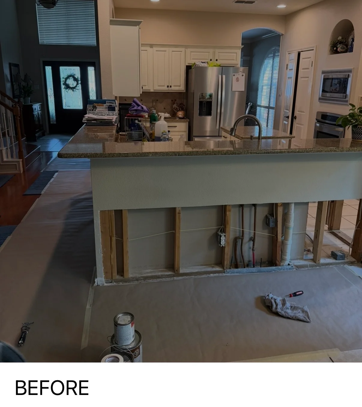 Kitchen island drywall installation in progress with finished framing and joint compound work