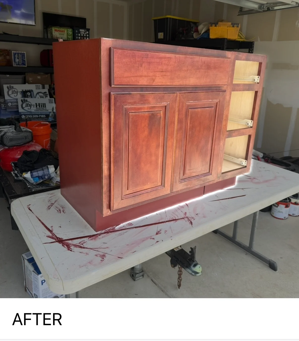 Rust-red stained wood cabinet with two panel doors and three open shelves, freshly finished