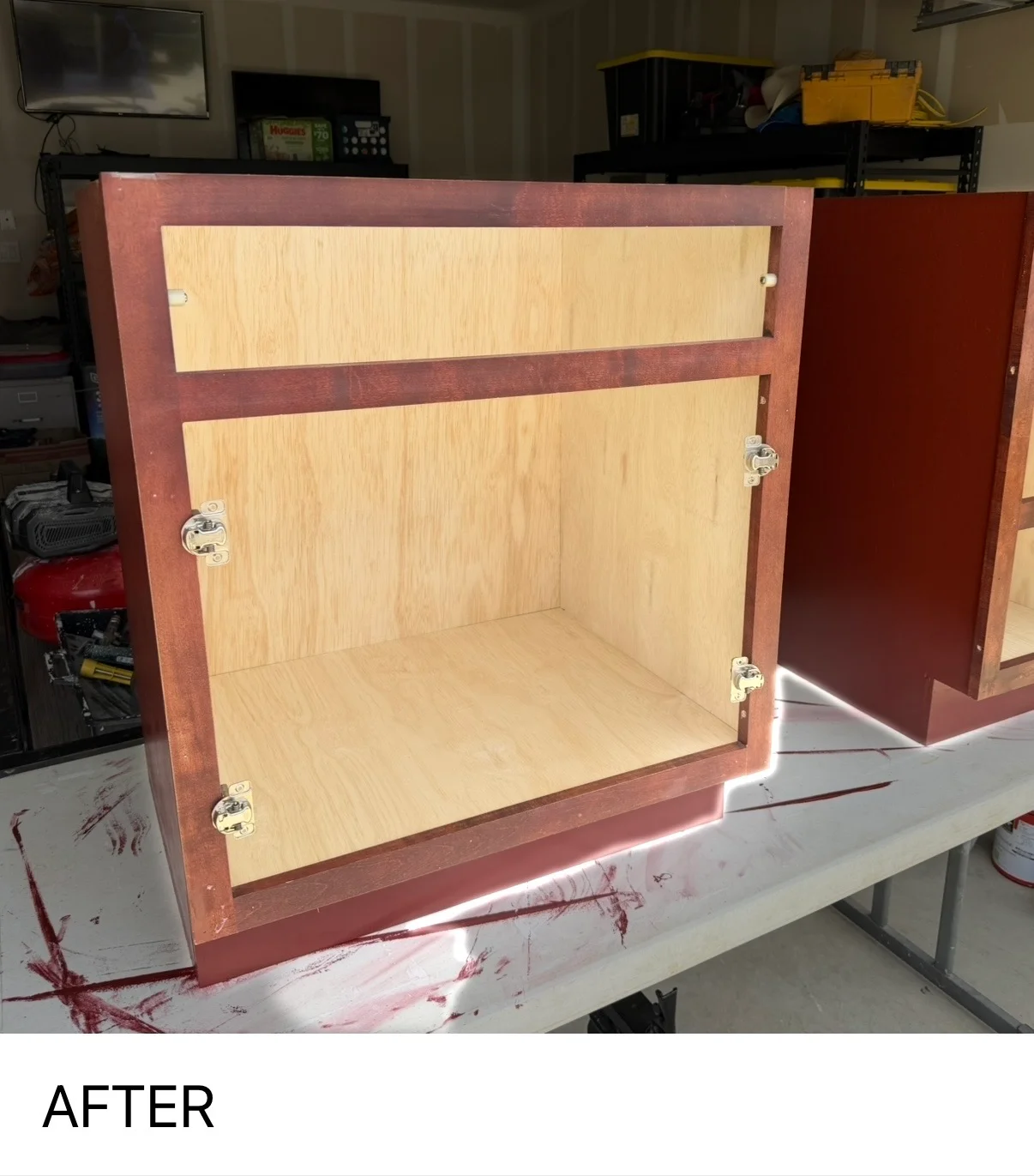Refinished wooden cabinet with burgundy frame and light wood interior shelving